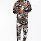 Full-length front view of a model wearing Stylia's full camouflage print track pants with high-contrast athletic side stripes in the US.